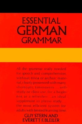 Open book showing pages of "Essential German Grammar" by Dover Publications with German language rules and grammar explanations.